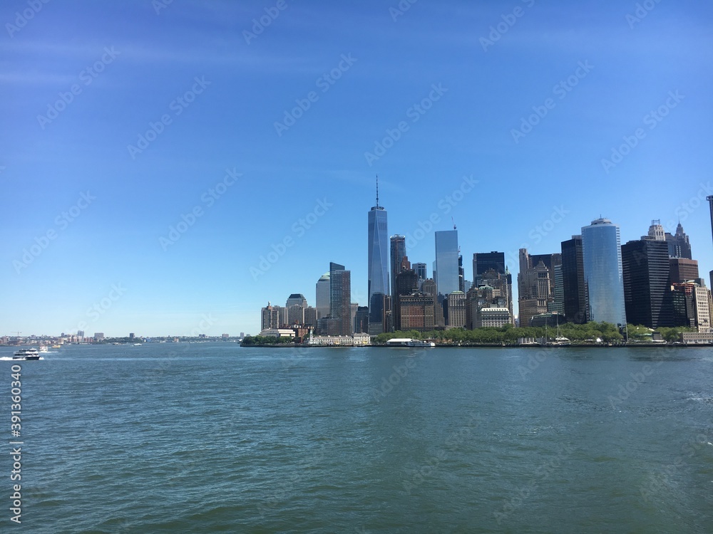 Scenic view of the New York Manhattan skyline seen from the ferry boat. Scenic view of the New York Manhattan skyline seen from the ferry boat.