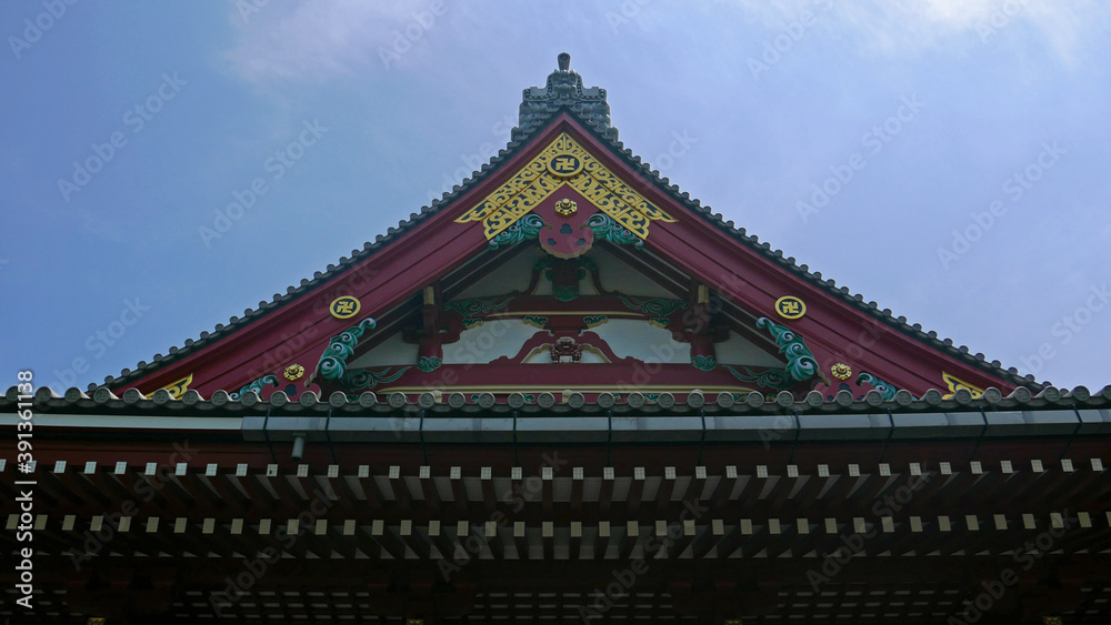 Roof of a beautiful ancient buddhist temple in japan predominating de color red