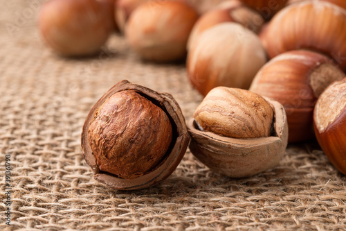 Hazelnuts on a burlap macro shot. Healthy vegetarian eating, antioxidant and protein source. Ketogenic and raw food diets ingredient.