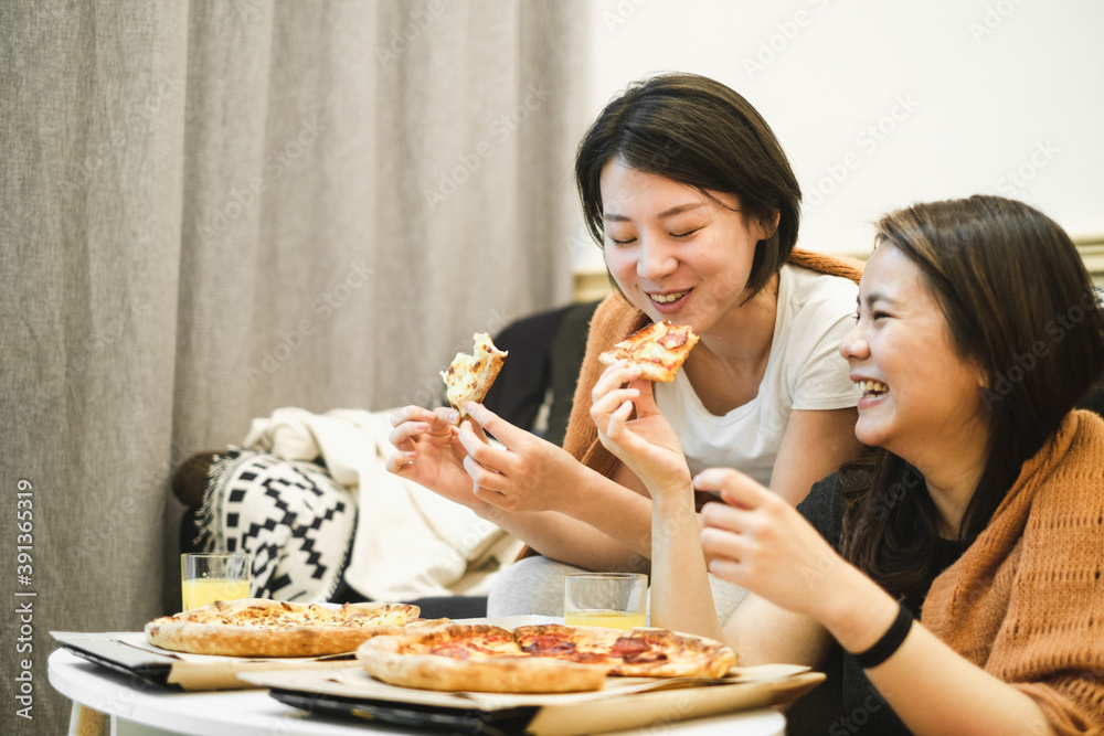 Two Girlfriends Having Pizza At Home Together Two Girlfriends Having Pizza At Home Together