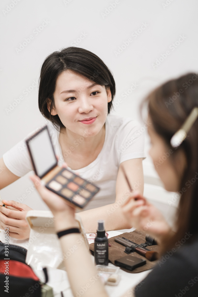 Two Young Friends Applying Makeup At Home Two Young Friends Applying Makeup At Home