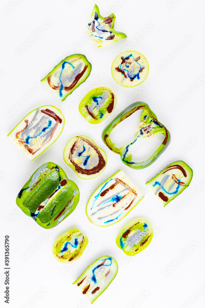 Collection of green vegetables and fruits on a white background. Vegetable pattern of green vegetables. Bell peppers, tomatoes, cucumber, cabbage, zucchini and apple in dyes. Top view