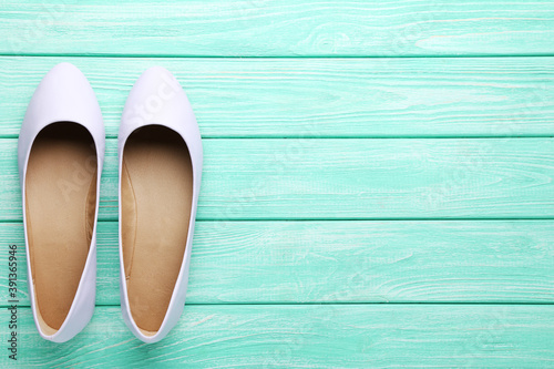 Purple female shoes on mint wooden table