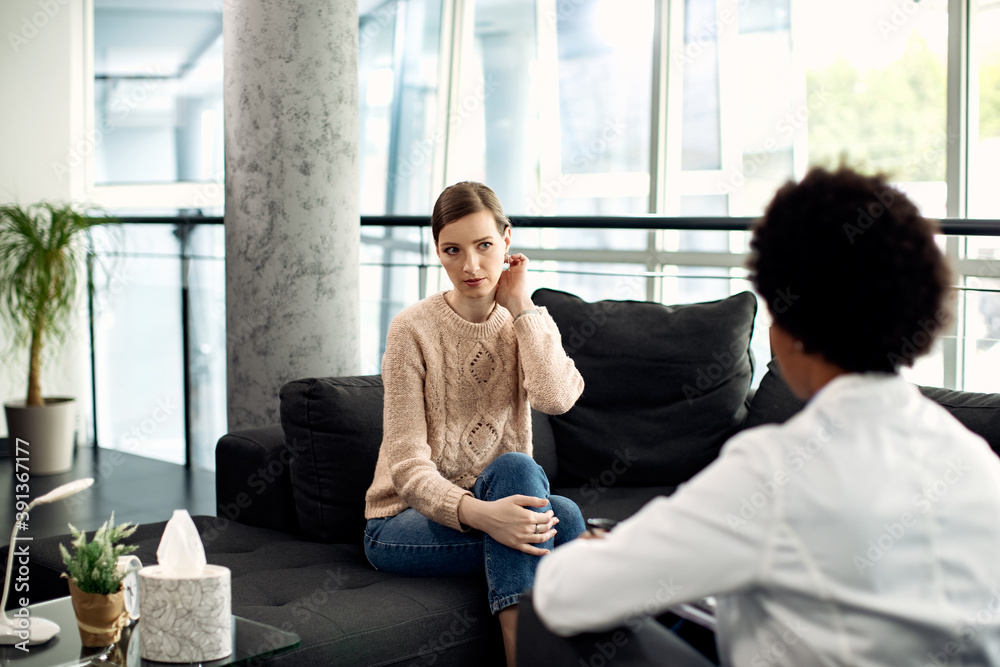 Young woman having appointment with a therapist at doctor's office. Young woman having appointment with a therapist at doctor's office.