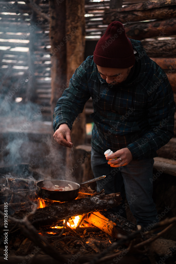 Winter holidays. Picnic fire and fried eggs in the pan.