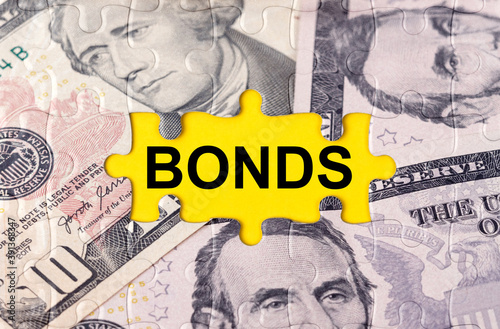 Puzzle with the image of dollars in the center of the inscription -BONDS