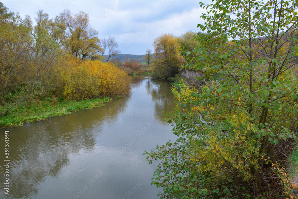 Autumn landscape with a small river