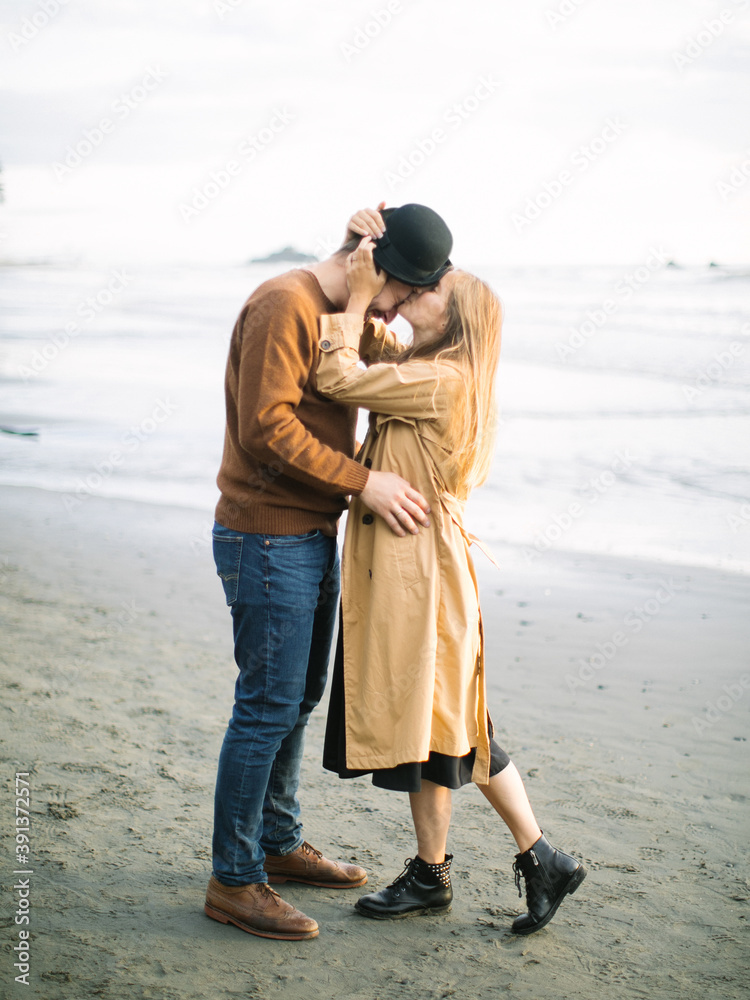 A Couple walking and kissing at the ocean shore A Couple walking and kissing at the ocean shore