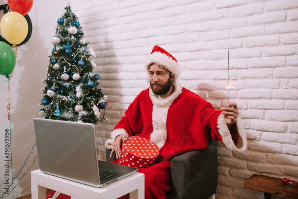 Santa Claus video calling kid talking to kid, Merry Christmas, Happy New Year in virtual video online chat meeting on laptop sitting at workshop table sending gift on xmas eve. Gift and sparkles Santa Claus video calling kid talking to kid, Merry Christmas, Happy New Year in virtual video online chat meeting on laptop sitting at workshop table sending gift on xmas eve. Gift and sparkles