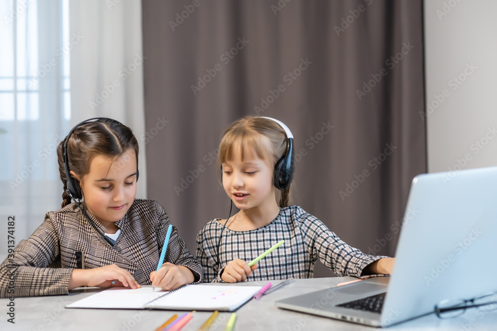 Portrait of two person nice-looking attractive charming cute lovely positive funny cheerful cheery girls researching subject browsing doing homework in light white interior class room indoors Portrait of two person nice-looking attractive charming cute lovely positive funny cheerful cheery girls researching subject browsing doing homework in light white interior class room indoors