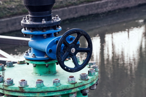 Foto Industrial water tap on the creek damb