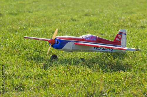 radio-controlled aircraft plane on a grassy airport, RC plane on grass,
RC aircraft