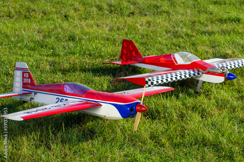 radio-controlled aircraft plane on a grassy airport, RC plane on grass,
RC aircraft