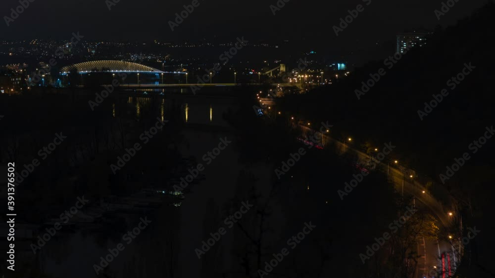 view of street lighting on bridges on the Vltava river in the city of Prague at night and lights from passing cars
view of street lighting on bridges on the Vltava river in the city of Prague at night and lights from passing cars