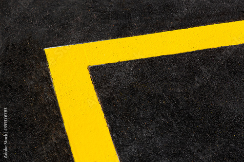 yellow markings angle of the new highway with tarmac road surface close up asphalt texture of bitumen roadside route, nobody. © Александр Беспалый