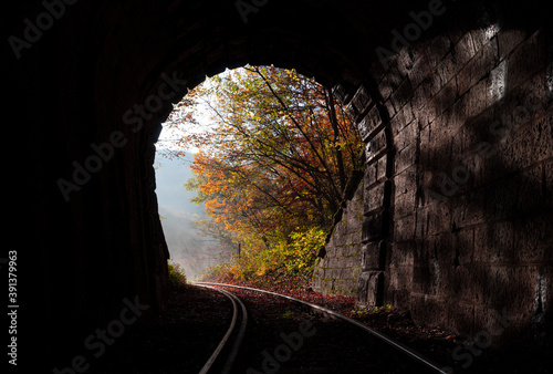 A railway coming out of the tunnel and the autumn light