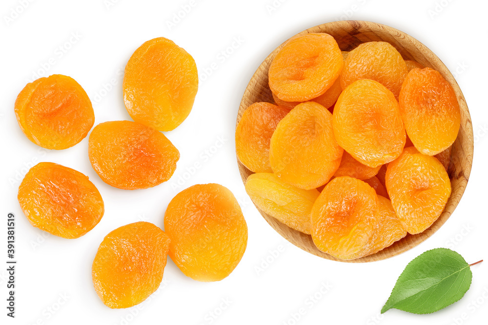 Dried apricots in wooden bowl isolated on white background . Top view. Flat lay Dried apricots in wooden bowl isolated on white background . Top view. Flat lay