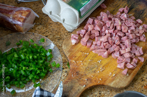 Photography Preparation of a Brazilian meal, with sliced pork sausage, parsley, eggs and bac