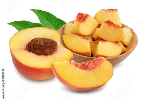 Ripe peach fruit slices in wooden bowl isolated on white background with clipping path and full depth of field
