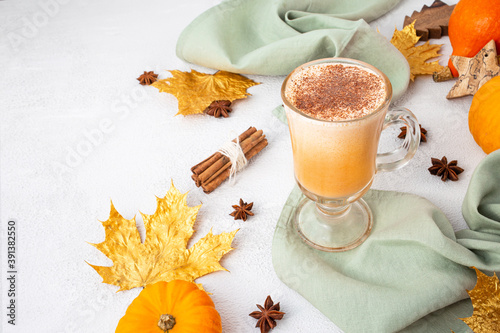 Pumpkin latte with whipped cream and spices on white background. Copy space.