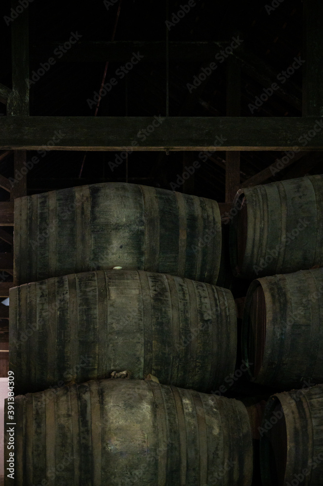 Old porto lodge with rows of oak wooden casks for slow aging of fortified ruby or tawny porto wine in Vila Nova de Gaia, Portugal Old porto lodge with rows of oak wooden casks for slow aging of fortified ruby or tawny porto wine in Vila Nova de Gaia, Portugal