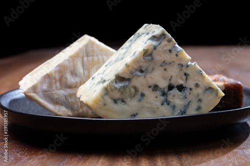 Cheese collection, blue cheese, camembert, brie served as dessert with fig almonds bread photo