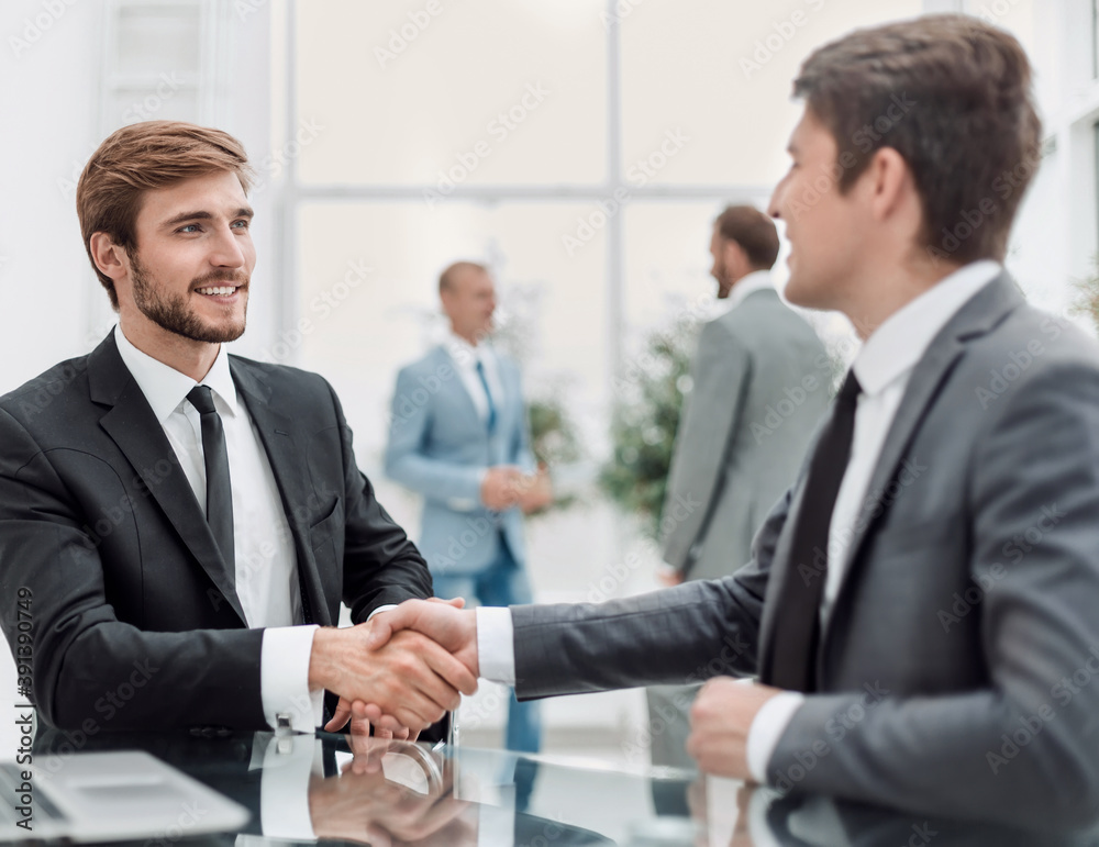 close up. handshake of business people at the Desk close up. handshake of business people at the Desk