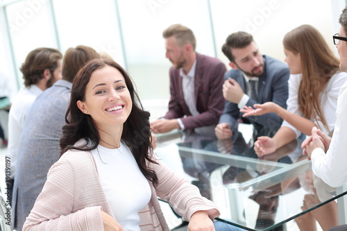 young business woman sitting at corporate business team meeting .