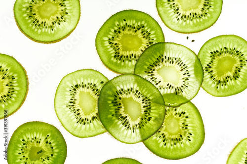 Canvas Print Pattern with backlit kiwi fruit slices on white background