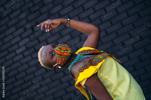 Woman wearing African inspired face mask during covid-19 pandemic photo