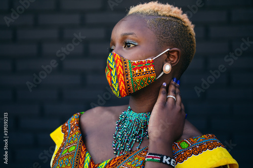Woman wearing African inspired face mask during covid-19 pandemic