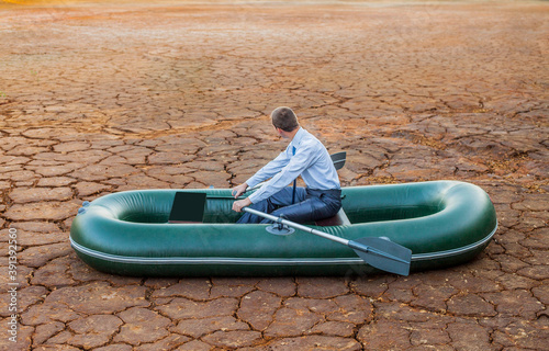 Dumb funny Business man stop on crack soil hot land desert boat businessman rock look bright future symbol crisis stagnation losses braking difficulties environmental disaster water scarcity drought photo