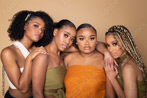 Studio portrait of four beautiful black female friends photo