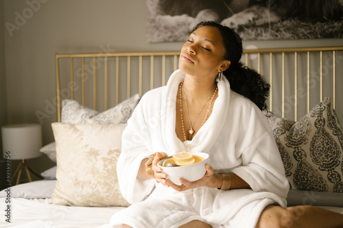 Black woman self care Sunday at home in bed photo