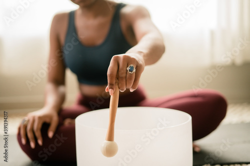 Woman using stress relieving singing bowl photo