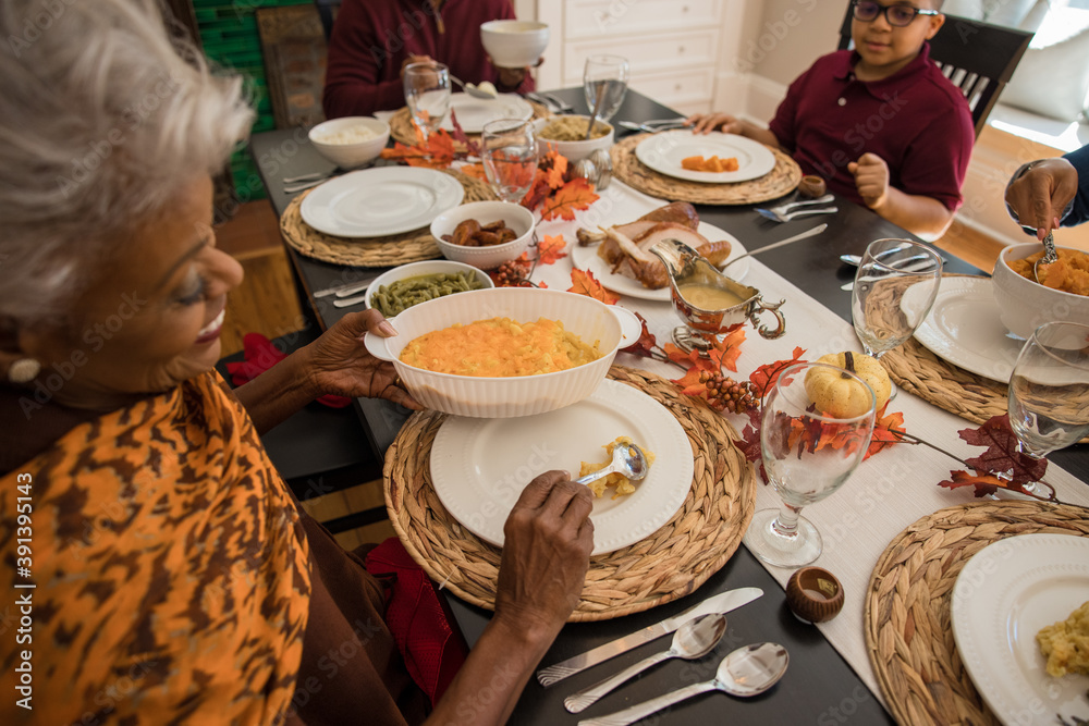 Black multigenerational family eating Thanksgiving holiday meal Stock