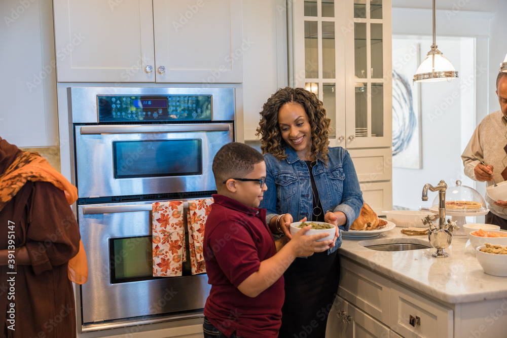 Family prepares Thanksgiving food in kitchen Family prepares Thanksgiving food in kitchen