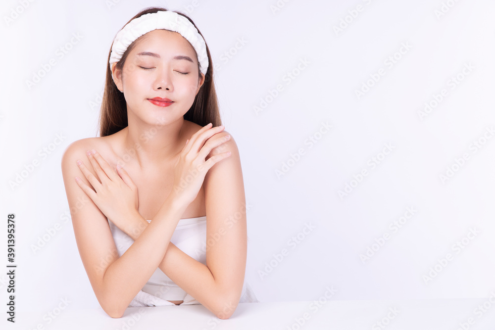 Charming young woman wear headband touching body with clean fresh body. Teenager before bathing while close her eyes over isolated white background. Beauty cosmetics and healthy skin concept. Charming young woman wear headband touching body with clean fresh body. Teenager before bathing while close her eyes over isolated white background. Beauty cosmetics and healthy skin concept.