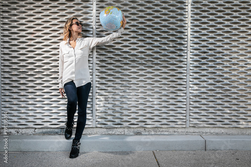 Canvas Print Young Woman Holding Inflatable Globe