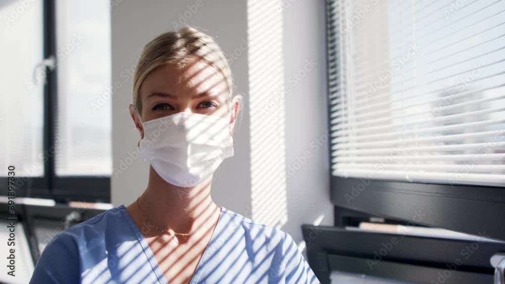 Portrait of doctor with face mask looking at camera, coronavirus, covid-19 and vaccination concept.