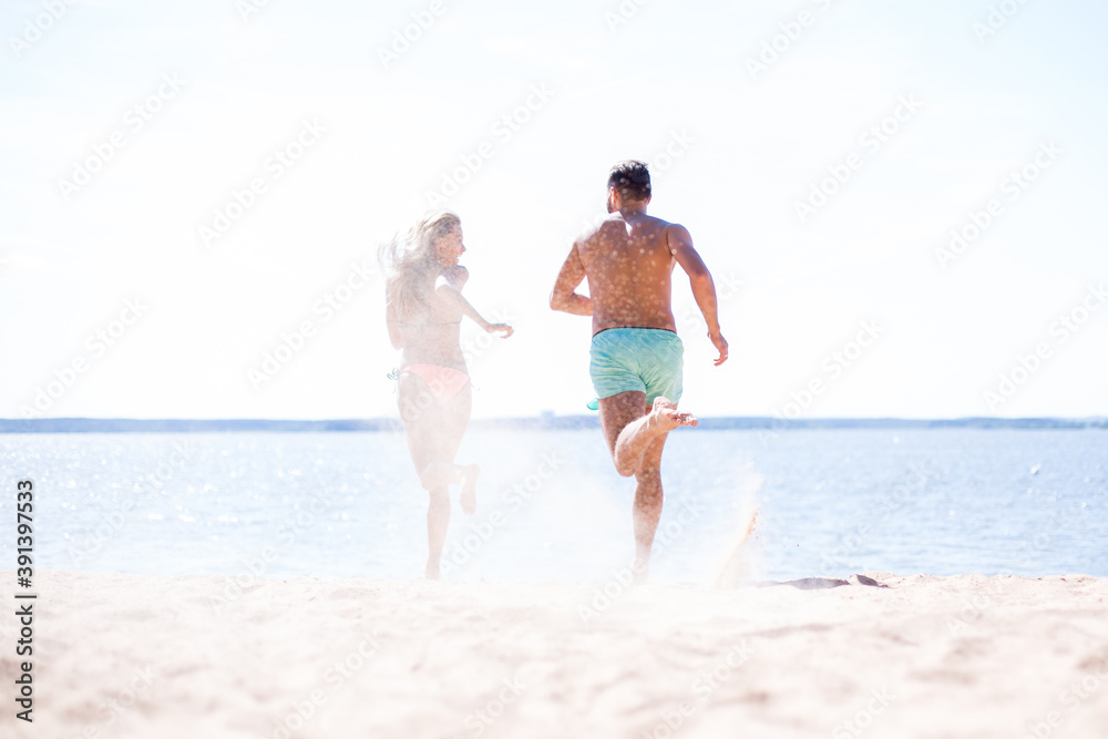 Couple running on beach.