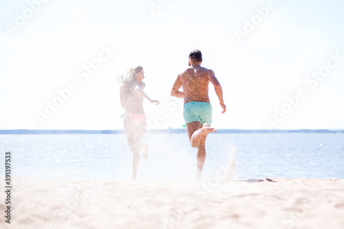 Couple running on beach.