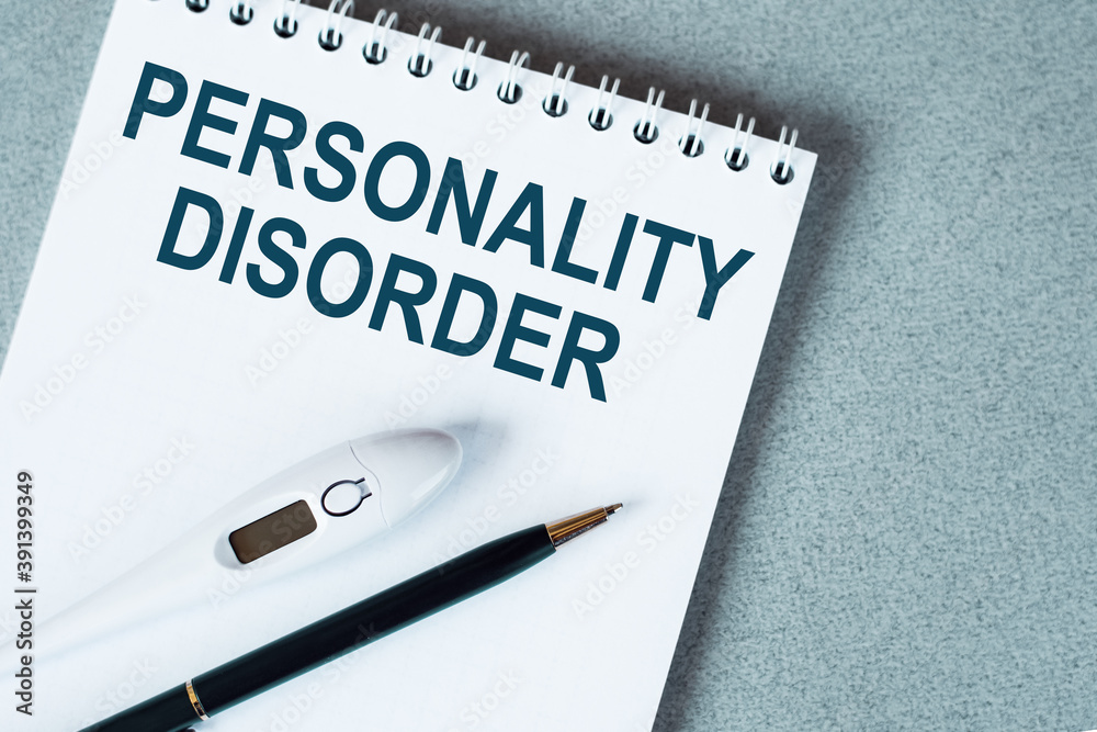 Blank notebook with thermometre and pen on table. Personality disorder text Blank notebook with thermometre and pen on table. Personality disorder text