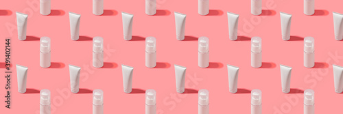 Trendy sunlight beauty pattern made with Blank white tube cream on bright light pink background, copy space, mock up, banner