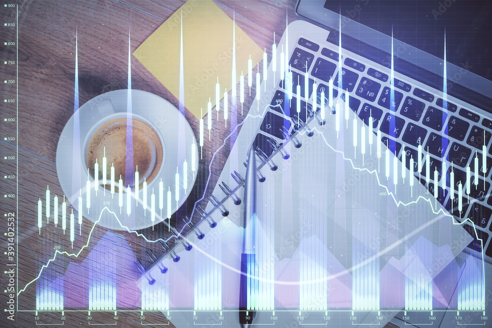 Double exposure of forex chart drawing over table background with computer. Concept of financial research and analysis. Top view.