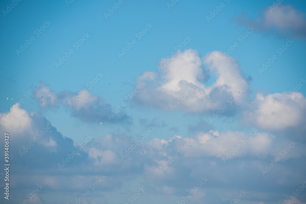 Blue sky background with white dramatic clouds and sunlight, sky background Blue sky background with white dramatic clouds and sunlight, sky background