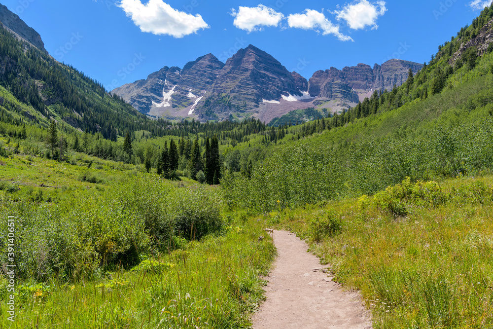 Hiking at Maroon Bells - Summer view of a hiking trail in Maroon Creek Valley at base of Maroon Bells. Aspen, Colorado, USA.