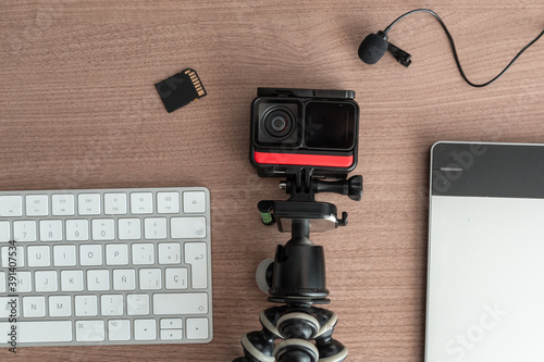 different technological gadgets on the work desk, there is a camera, microphone, sd card, keyboard, technology and modern objects photo