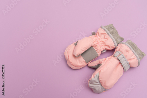 baby peach waterproof mittens on a lilac background