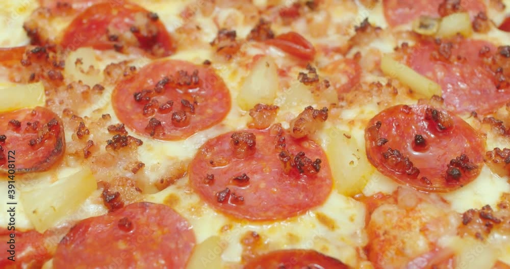 Macro slider shot of a pepperoni. bacon and pineapple pizza. Cinematic 4K footage. Macro slider shot of a pepperoni. bacon and pineapple pizza. Cinematic 4K footage.